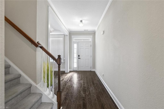 entrance foyer featuring ornamental molding and hardwood / wood-style flooring