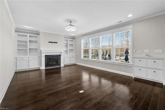 unfurnished living room with built in shelves, ornamental molding, and dark hardwood / wood-style flooring