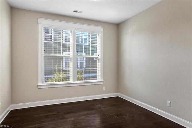 empty room with dark wood-type flooring