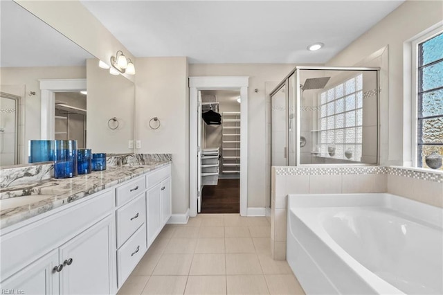 bathroom with tile patterned flooring, shower with separate bathtub, and vanity