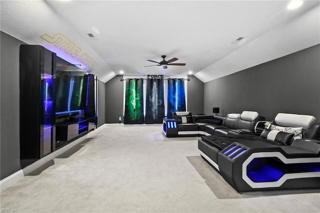 home theater room with lofted ceiling, carpet floors, and ceiling fan