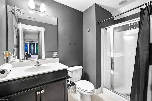 bathroom featuring toilet, a shower with door, and vanity