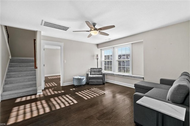 living room with ceiling fan and dark hardwood / wood-style floors