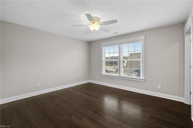 unfurnished room with ceiling fan and dark hardwood / wood-style flooring