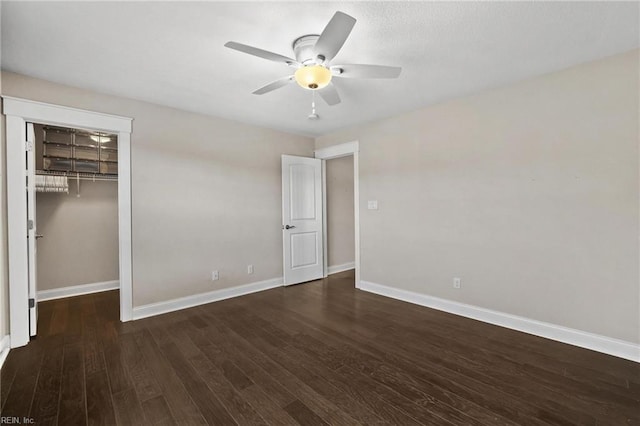 unfurnished bedroom featuring dark hardwood / wood-style flooring, a closet, and ceiling fan