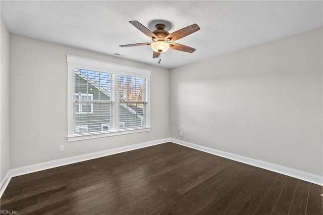 spare room with ceiling fan and dark wood-type flooring