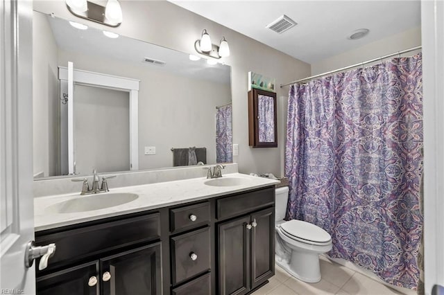 bathroom with tile patterned floors, vanity, and toilet