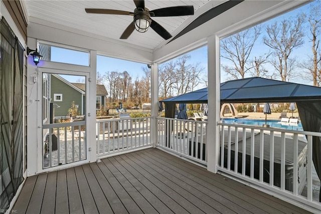 unfurnished sunroom with ceiling fan and lofted ceiling