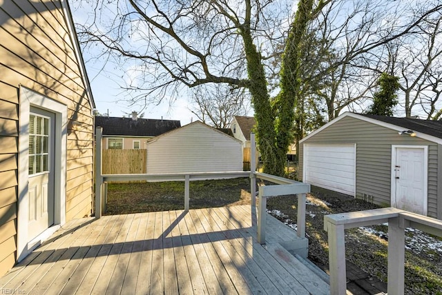 wooden deck featuring a garage and an outdoor structure