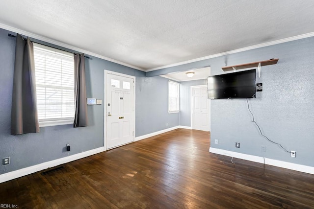 entryway with a textured ceiling, hardwood / wood-style floors, and crown molding