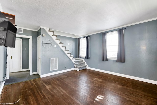 basement featuring ornamental molding, dark hardwood / wood-style flooring, and a textured ceiling