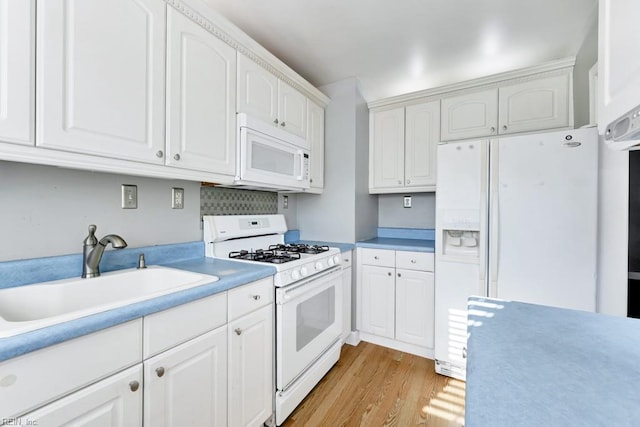 kitchen featuring white appliances, light hardwood / wood-style flooring, white cabinetry, and sink