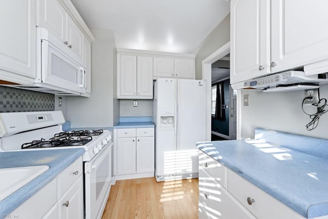 kitchen featuring white appliances, white cabinets, backsplash, and light hardwood / wood-style flooring