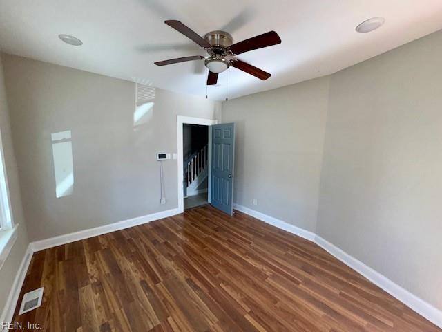 unfurnished bedroom with ceiling fan and dark hardwood / wood-style floors