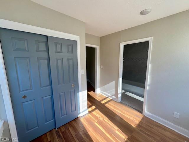 interior space featuring a closet and dark hardwood / wood-style flooring