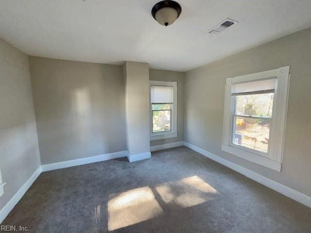 empty room with dark colored carpet