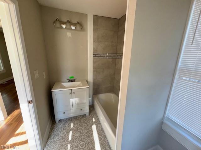 bathroom with vanity, tile patterned flooring, and a bathing tub