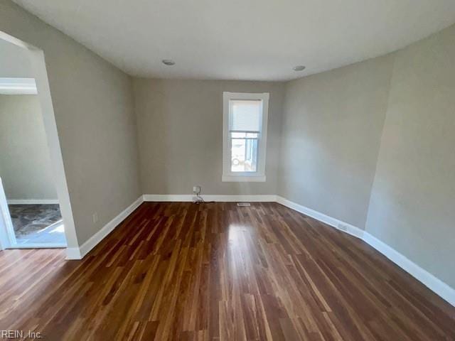 spare room with dark hardwood / wood-style flooring