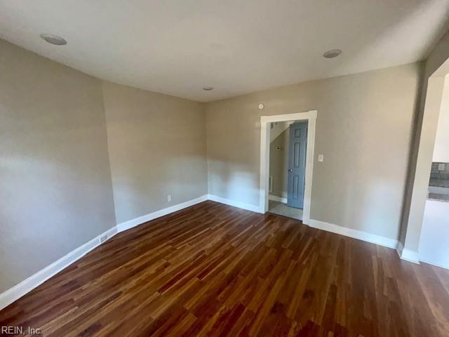 unfurnished room featuring dark hardwood / wood-style flooring