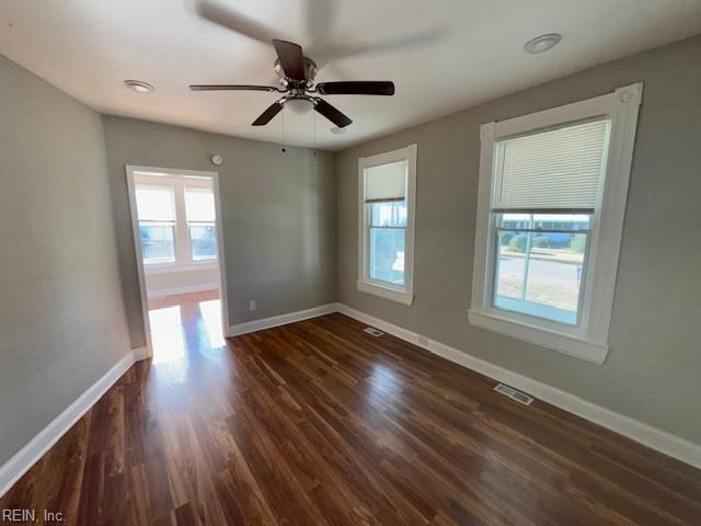 unfurnished room with ceiling fan and dark hardwood / wood-style floors