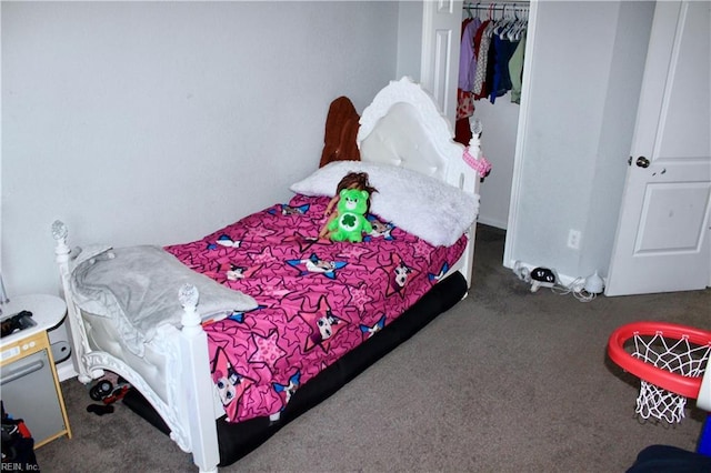 bedroom featuring a closet and dark colored carpet