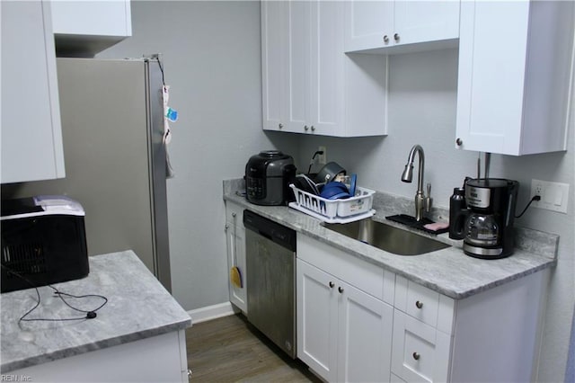 kitchen with sink, white cabinets, dark hardwood / wood-style floors, and stainless steel appliances