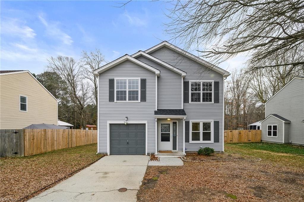 front of property featuring a garage and a front lawn