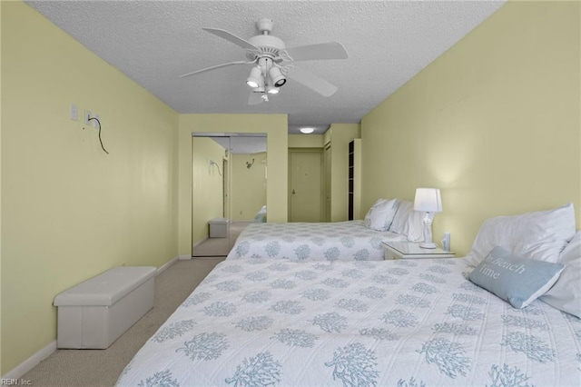 carpeted bedroom with a closet, ceiling fan, and a textured ceiling