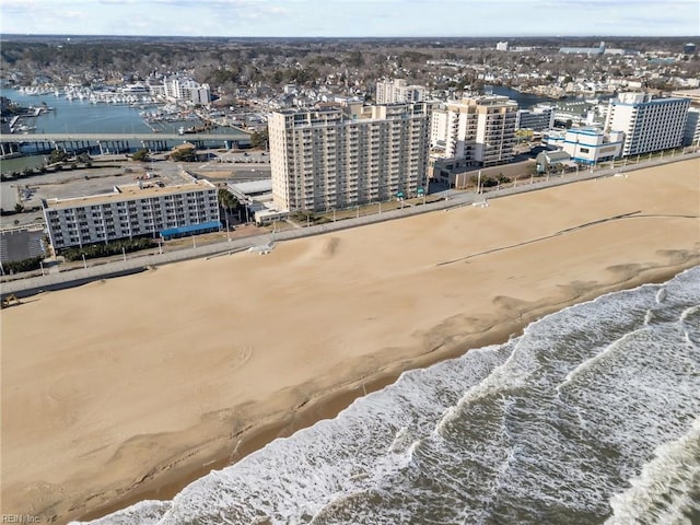 birds eye view of property with a view of the beach and a water view