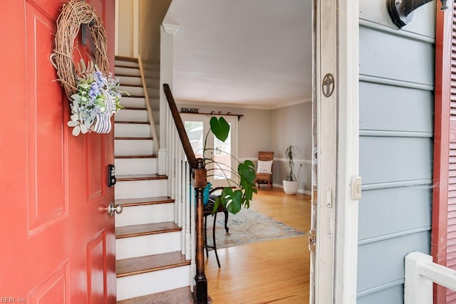 interior space with crown molding and wood-type flooring