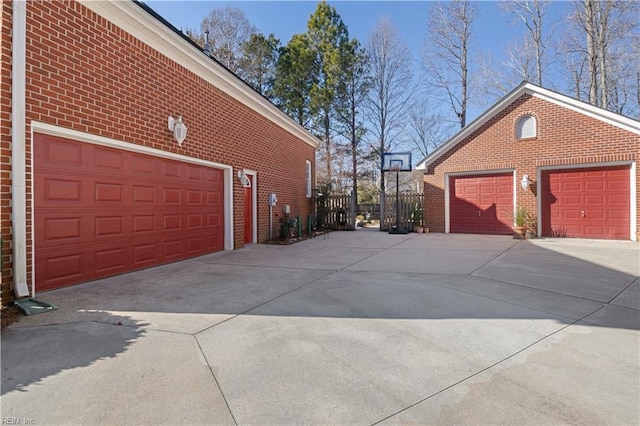 view of side of property with a garage and an outbuilding