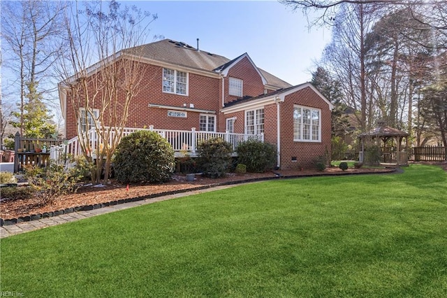 back of house with a lawn, a wooden deck, and a gazebo