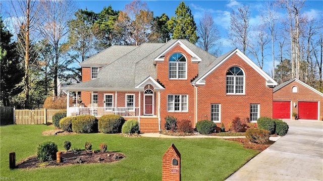 view of front property featuring a garage, a porch, and a front lawn