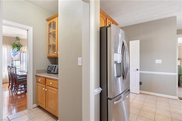 kitchen with light tile patterned flooring and stainless steel fridge with ice dispenser