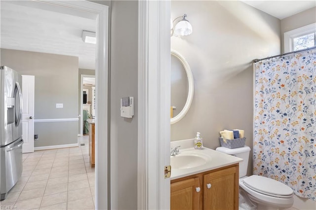 bathroom featuring vanity, a shower with curtain, tile patterned floors, and toilet