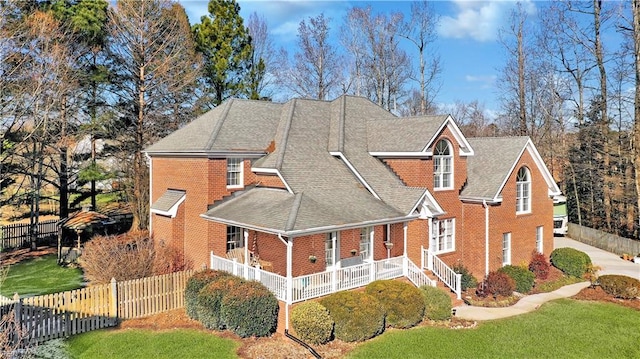 view of front of house with a porch and a front lawn