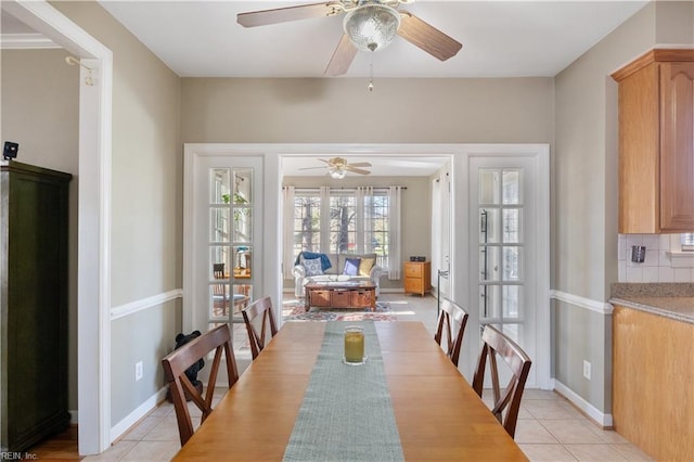 dining area featuring ceiling fan and light tile patterned floors