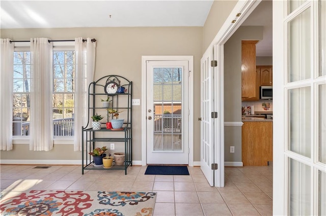 entryway with french doors and light tile patterned flooring