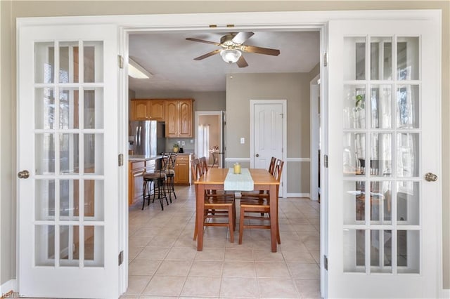 tiled dining room with ceiling fan