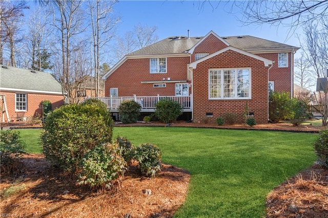 back of house featuring a yard and a wooden deck