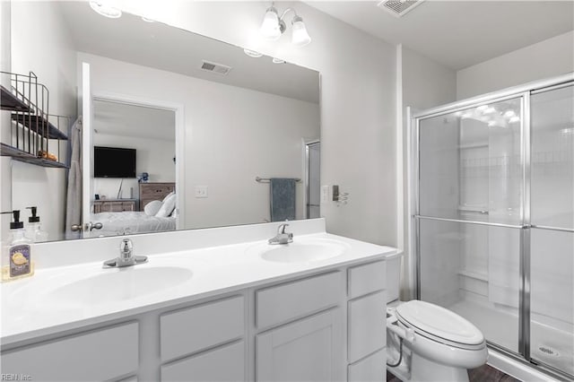 bathroom with toilet, an inviting chandelier, walk in shower, and vanity