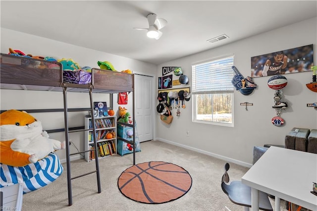 bedroom with a closet, ceiling fan, and light colored carpet