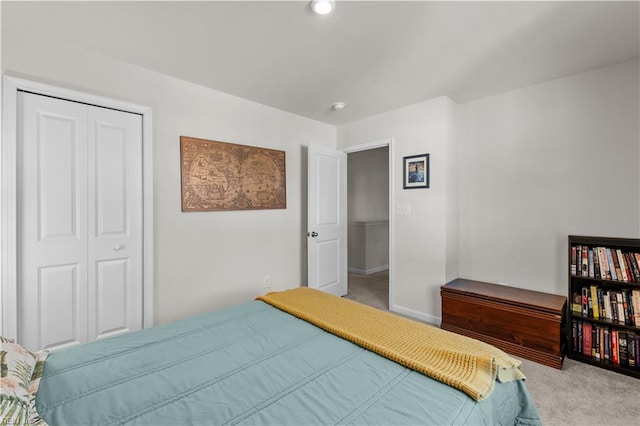 bedroom with a closet and light carpet