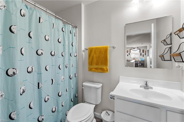 bathroom featuring toilet, a shower with shower curtain, and vanity