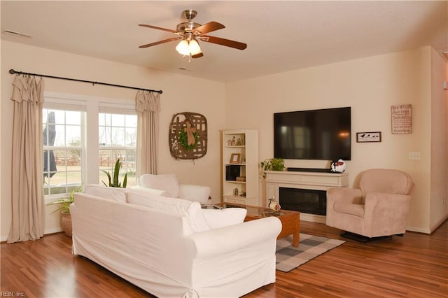 living room featuring ceiling fan and hardwood / wood-style flooring