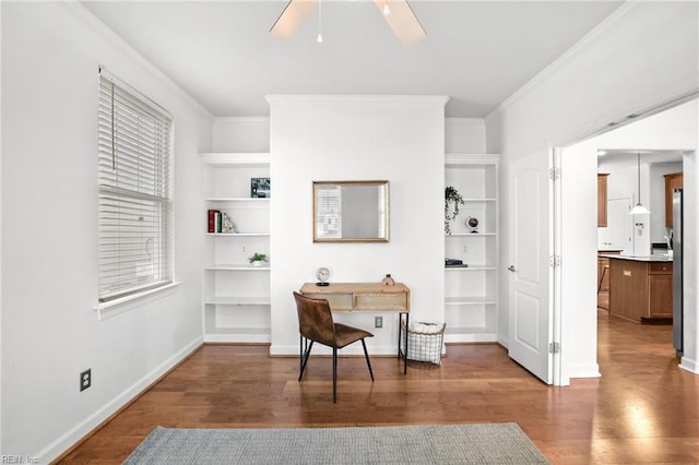 office space featuring hardwood / wood-style flooring, built in features, crown molding, and ceiling fan