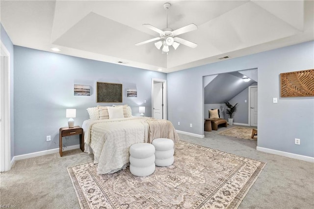 bedroom featuring light carpet, ceiling fan, lofted ceiling, and a raised ceiling