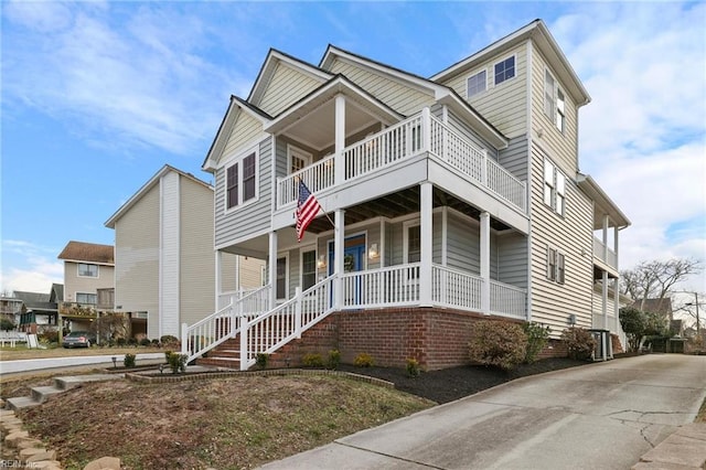 view of front of property with a porch and a balcony