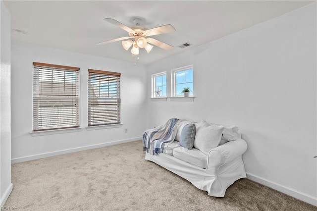 sitting room featuring ceiling fan and light colored carpet