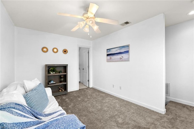 living area featuring ceiling fan and dark colored carpet